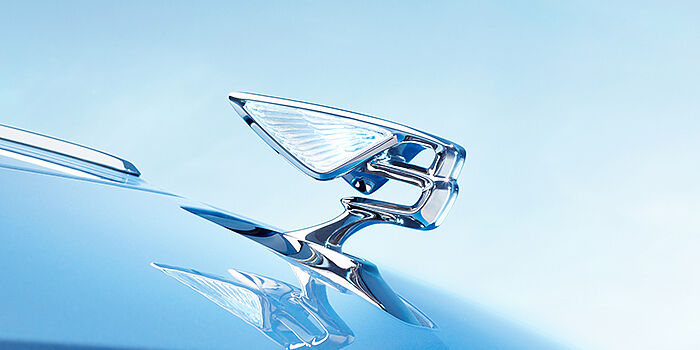 Porsche Inter Auto Bulgaria Bentley Flying Spur Azure sedan bonnet close up in Light Windsor Blue paint with Illuminated Flying B mascot